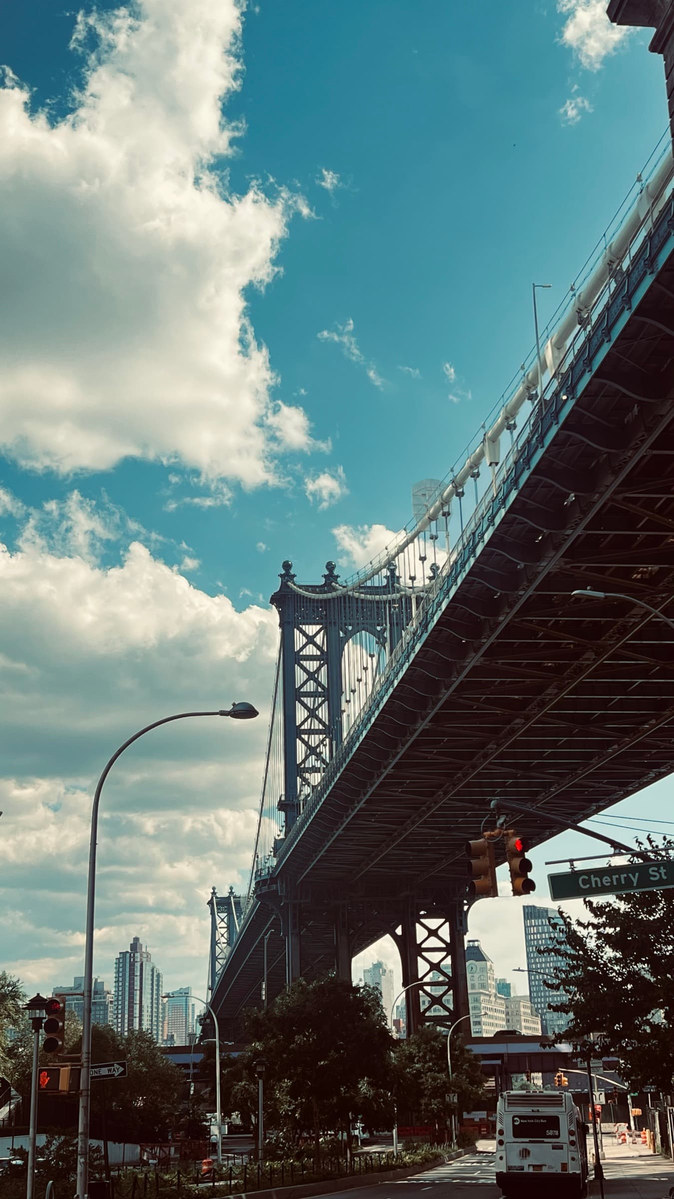 Manhattan Bridge overhead from Cherry Street with clouds